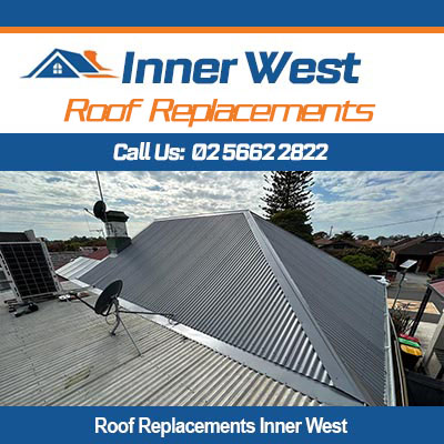 Roof replacement in Inner West with roofers installing corrugated metal roofing on residential home